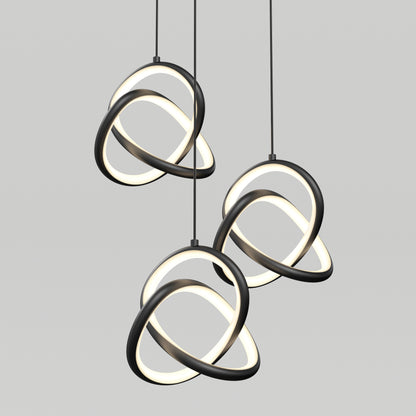 Artika’s Zephyr 3-light LED pendant features interlocking black and white illuminated rings suspended against a plain light gray background, delivering a contemporary, artistic look.
