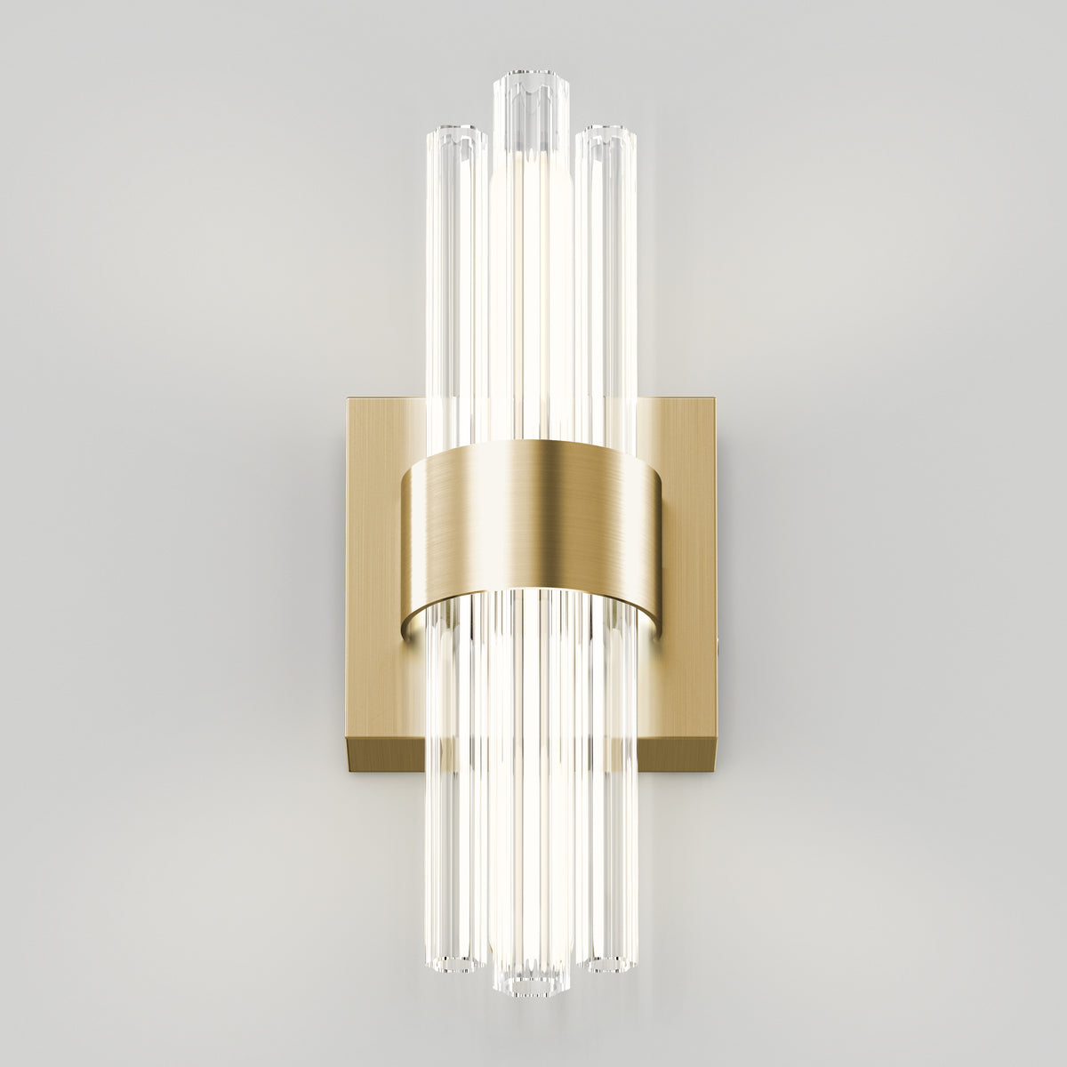 Wall-mounted light fixture with a modern design featuring vertical glass rods radiating from a central brass base and band, emitting soft, diffused light against a plain white background.