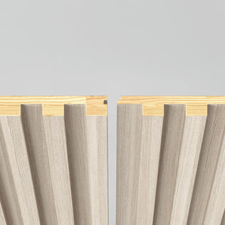 Two Artika Panolok 30.67 ft wall panel kit sections in beige feature wood-paneled, wavy grooved surfaces and interlocking edges, displayed side by side on a light gray background with natural wood tops.