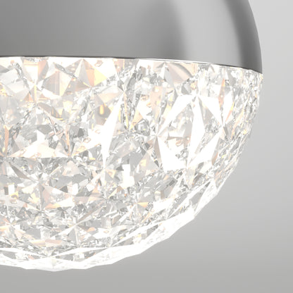 Close-up of Artika’s Carat LED pendant light 3 CCT, featuring a textured faceted glass shade and smooth metallic rim, emits a soft, sparkling glow.