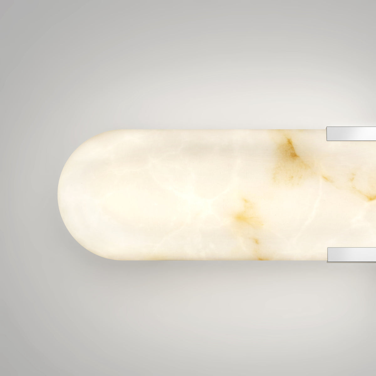 A minimalist, oval-shaped wall sconce with a marbled white and light brown surface and two silver metallic accents on a light gray background.