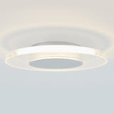 Close-up of a modern, circular ceiling light fixture with a glowing outer ring and a frosted, textured surface, mounted on a white ceiling.