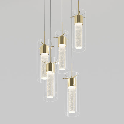 The Artika Essence 5-light LED pendant features modern cylindrical glass shades with gold fittings, each hanging at different heights. Inner tubes contain small bubbles for a sparkling, illuminated effect.