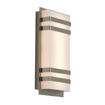A modern wall sconce with a rectangular frosted glass shade, featuring three horizontal metallic bands and a metallic backplate, illuminated with a soft, warm light.