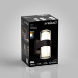 A black box displays an Artika Colton wall light fixture with images of the light installed, product features, and icons showing LED, 30,000 hours, 500 lumens, and 5-year warranty.