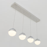 A modern ceiling light fixture with four spherical pendants, each half chrome and half frosted glass, suspended in a row from a rectangular metallic base. All four lights are illuminated.
