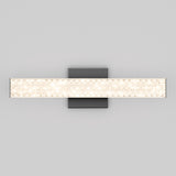 A modern wall-mounted light fixture with a rectangular frosted glass shade and a textured pattern, attached to a square metallic base against a plain light gray background.