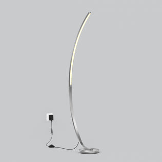The Artika Arc LED Floor Lamp features a modern arched design with a slim metallic base and integrated dimmable LED light, plugged into a wall socket against a plain gray background, offering adjustable brightness and stylish ambiance for any room.