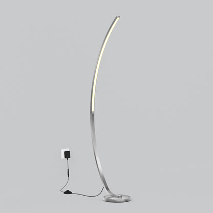 The Artika Arc LED Floor Lamp features a modern arched design with a slim metallic base and integrated dimmable LED light, plugged into a wall socket against a plain gray background, offering adjustable brightness and stylish ambiance for any room.