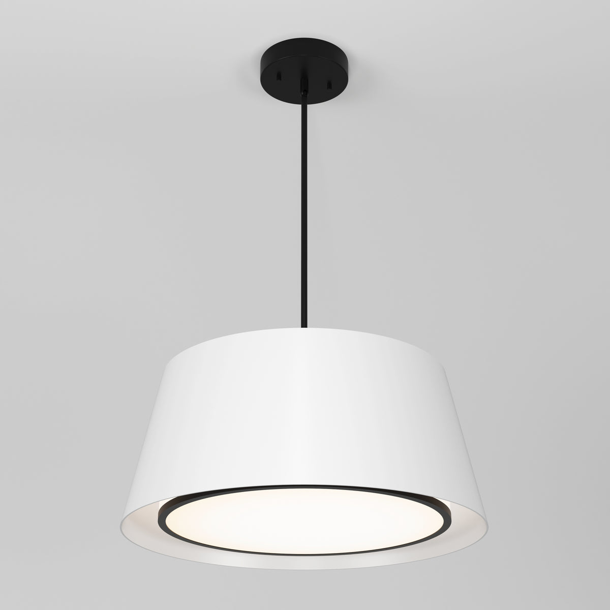 The Artika Cappa LED pendant light 3 CCT features a modern white drum shade with a black ceiling mount and cord, illuminated against a plain light gray background, casting a soft downward glow.