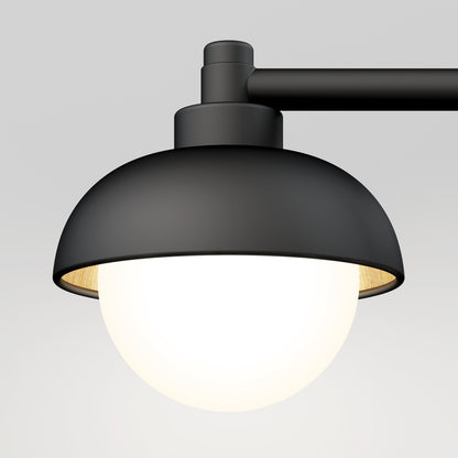 The Artika Boden LED mid-century bathroom vanity light features a modern black design with a round shade and glowing white bulb, mounted on a horizontal rod—an ideal accent for contemporary spaces.