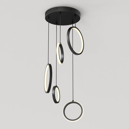 The Artika Elmo 5-light LED pendant features five circular LED rings of varying sizes, suspended at different lengths from a round black base, offering a modern lighting solution with adjustable color temperatures.