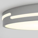 Close-up view of a modern, circular ceiling light fixture with a smooth, matte gray finish and illuminated white LED strips embedded around the edge.