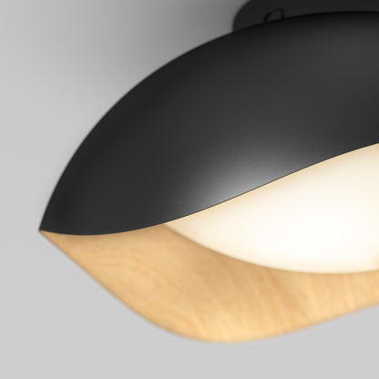 A close-up of the Artika Adara 15 in. LED flush mount light, featuring a black metal shade, smooth wood accent, and frosted white diffuser for soft, warm illumination with 5 selectable color temperatures.