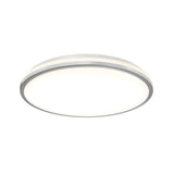 A modern, round, flush-mount ceiling light with a white diffuser and silver rim, emitting a soft, even glow.