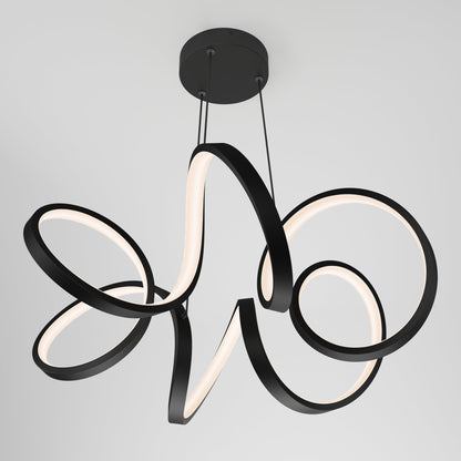 The Swirl Ribbon LED pendant light by Artika-CAN-dev features modern, looping ribbon-like arms in a matte black finish, suspended from a round ceiling mount against a plain white background.