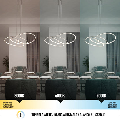 The Artika Swirl Butterfly LED contemporary pendant light (3 CCT) illuminates a dining room at warm white (3000K), neutral white (4000K), and cool white (5000K), each transforming the room’s ambiance and color.