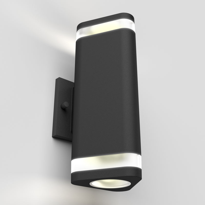 The Artika Trygon indoor-outdoor wall light features a modern black rectangular design with rounded edges and translucent bands on the top and bottom, providing both upward and downward illumination.