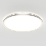 A modern, round ceiling light fixture with a white frosted cover and a slim metallic rim, emitting a bright, even glow against a plain white ceiling.