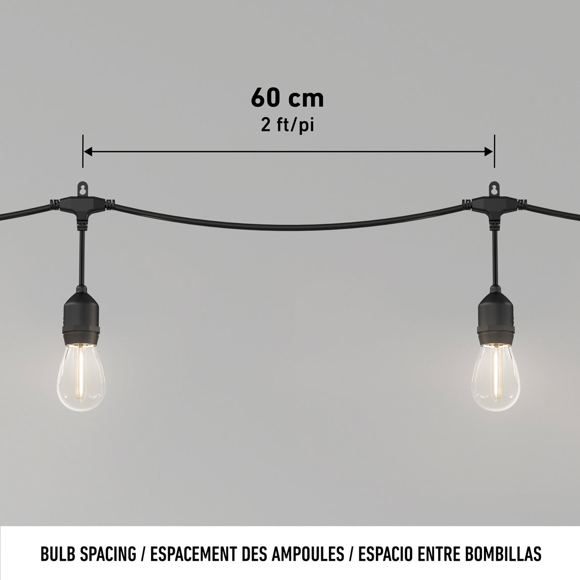Two Blaze 20 LED Outdoor Solar String Lights by Artika hang evenly on a black cable, with a label showing 60 cm (2 ft) spacing between bulbs. The background is plain light gray.
