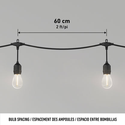 Two Blaze 20 LED Outdoor Solar String Lights by Artika hang evenly on a black cable, with a label showing 60 cm (2 ft) spacing between bulbs. The background is plain light gray.