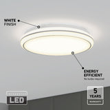 A round, flush-mount ceiling light with a white finish and integrated LED, glowing brightly. Text highlights its energy efficiency, no bulbs required, and a 5-year warranty. The ceiling and part of the wall are visible.