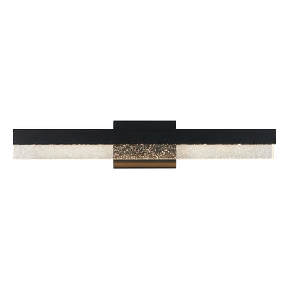 The Artika Bubble Bar LED bathroom vanity light features a modern wall-mounted design with a long black frame, central bronze accent, and a textured frosted diffuser beneath the frame.