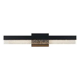 The Artika Bubble Bar 27-in Integrated LED Vanity Light Bar features a modern wall-mounted design with a black and gold base and a textured, clear glass panel for stylish bathroom lighting.