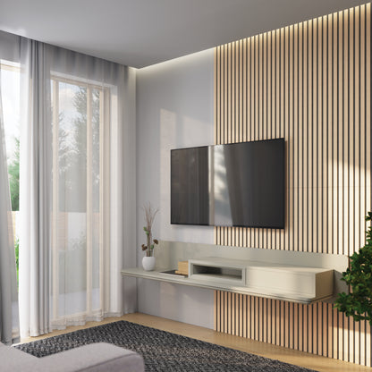 Modern living room featuring Artika’s Sonofold sound-absorbing wall panel kit (pack of 2) as a stylish accent, with a wall-mounted TV, floating shelf decor, potted plant, sheer curtains, and sunlight streaming through large windows.