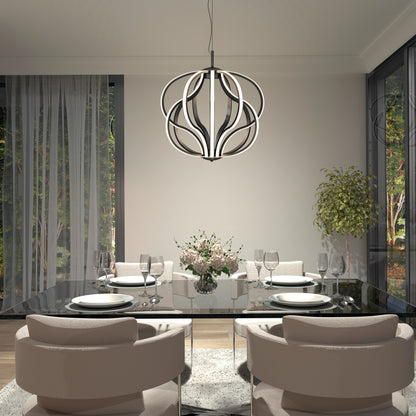 A modern dining room features a glass table for four, beige chairs, a floral centerpiece, large windows with sheer curtains, a potted plant, and the Artika Meridian LED pendant light hanging overhead.