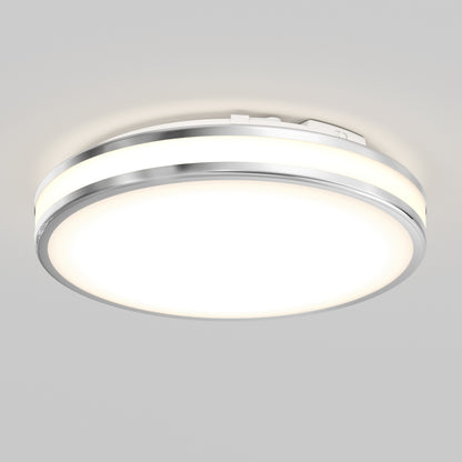 The Artika Hemisphere 15 in. LED flush mount light offers adjustable brightness and 5 CCT options, featuring a sleek chrome trim and bright white LED panel, stylishly mounted on a plain light gray ceiling.