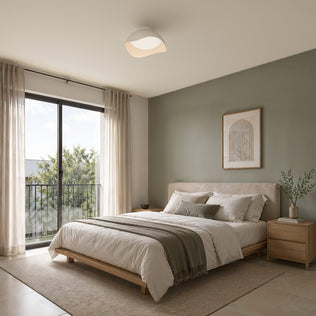 An Artika Adara 15 in. (38 cm) Modern LED Flush Mount Ceiling Light 5 CCT in a white, wave-shaped dimmable design installed in a bedroom.