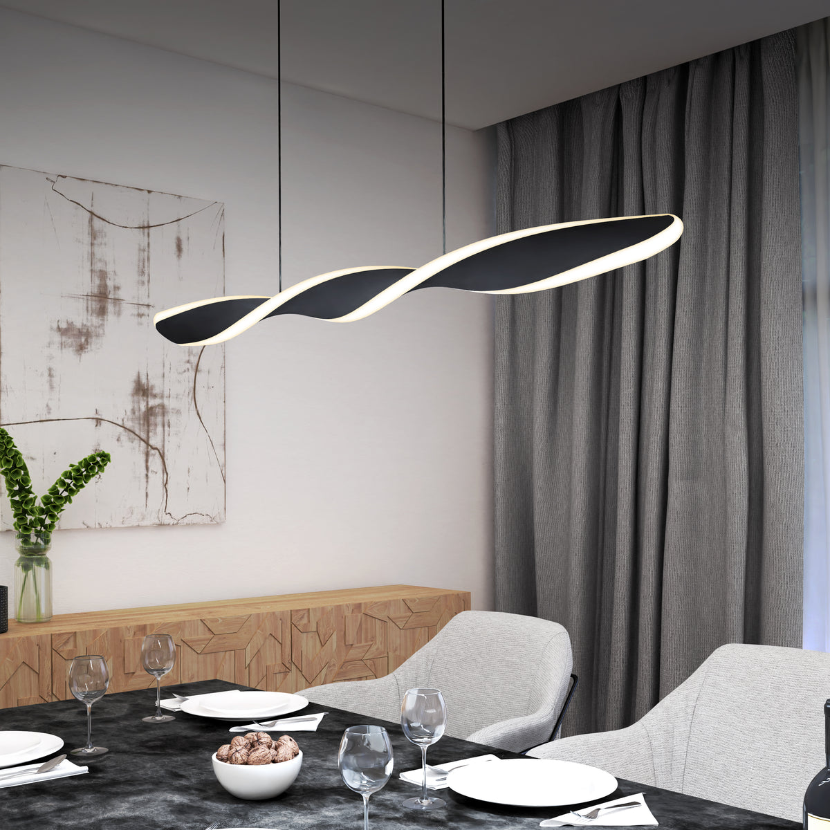 Modern dining room with a twisted, black-and-white LED pendant light hanging above a set table with four place settings, gray chairs, a bowl of chocolates, and a contemporary art piece on the wall.