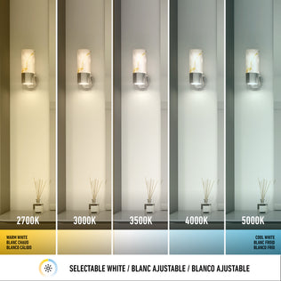 Artika’s Marble LED Contemporary Sconce 5 CCT features five wall sconces with selectable white color options, ranging from warm yellow (2700K) to cool white (5000K), each beautifully illuminating vases with diffuser sticks on a shelf.