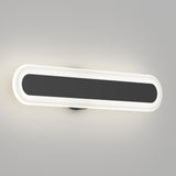 A modern, oval-shaped wall light fixture with a black center and a white illuminated border, mounted on a light gray wall.