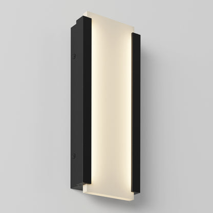 The Artika Blade indoor-outdoor LED wall light features a rectangular design with a frosted illuminated center panel and black side panels, mounted on a light gray wall.