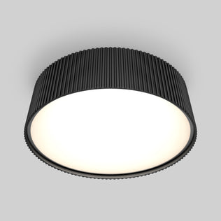 The Artika Groove 13 in. LED modern flush mount light features a ribbed black frame and bright white surface, offering 5 CCT options and a sleek look on any neutral gray ceiling.
