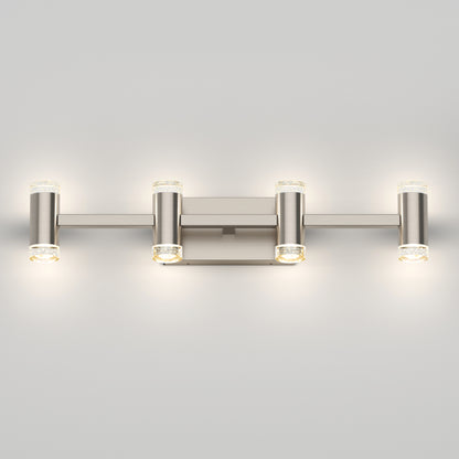 The Artika Mist modern LED bathroom vanity light 5 CCT is a wall-mounted fixture with a brushed metal finish and four cylindrical, illuminated lights arranged symmetrically on horizontal bars.