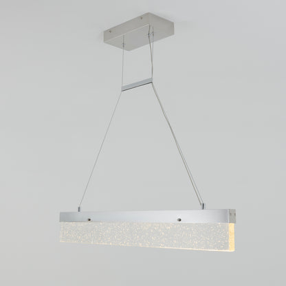 The Artika Essence Bar LED pendant light features a modern rectangular silver metal frame and a suspended frosted panel that emits soft, warm light with a sparkling bubble-like texture inside.