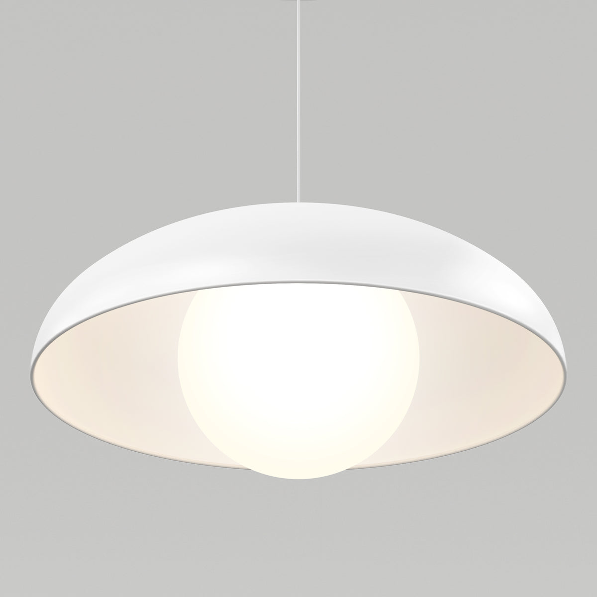 A modern white pendant lamp with a dome-shaped shade, hanging from the ceiling, emits a bright glow against a plain light gray background.