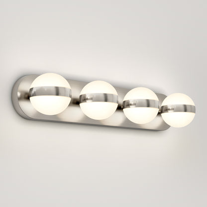 The Artika Baldric LED modern bathroom vanity light 3 CCT features four frosted glass globes with metallic bands, mounted on a brushed metal rectangular base for a stylish, wall-mounted look.