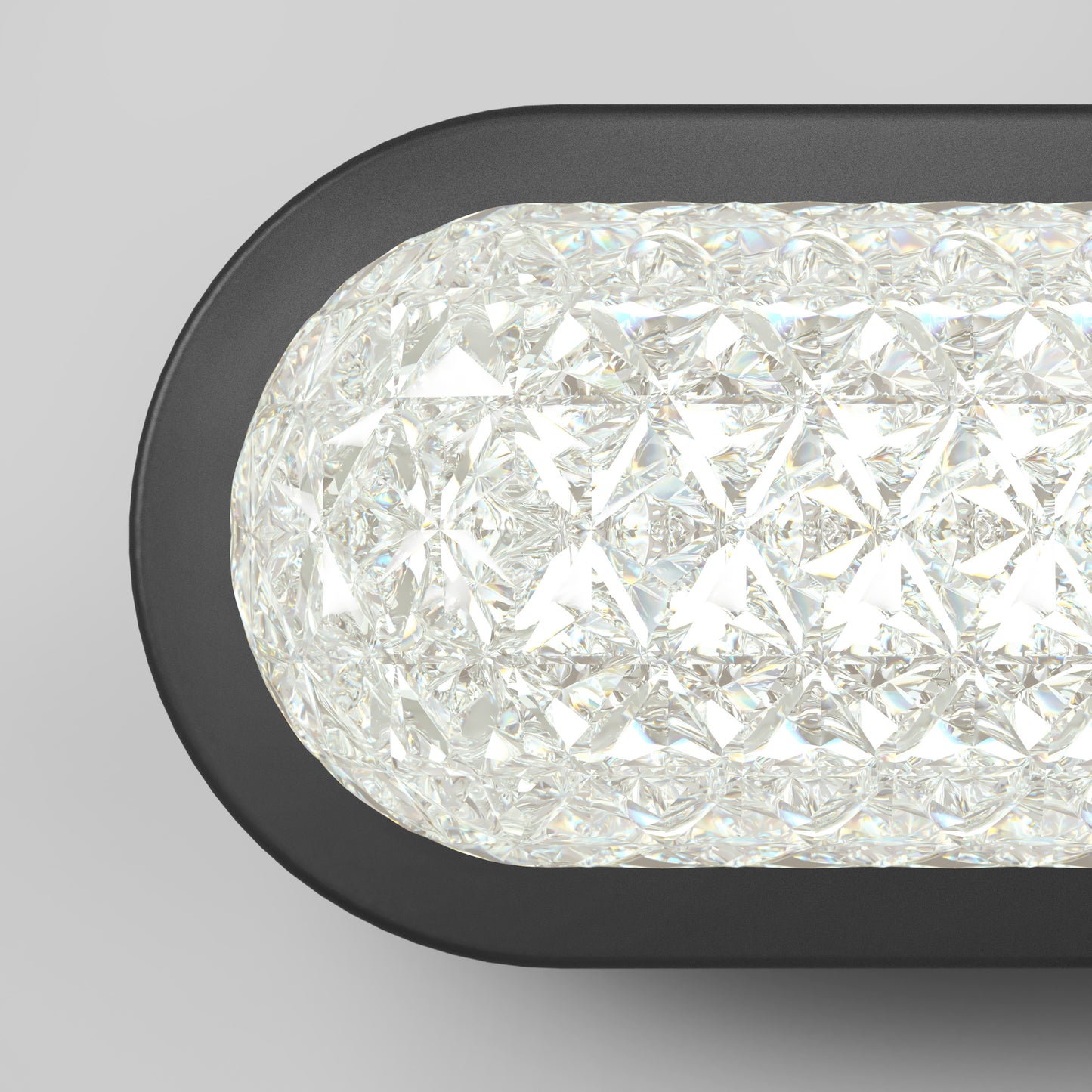 A close-up of the Artika Carat LED contemporary bathroom vanity light with a black frame and textured crystal-like glass, emitting bright white light; features 3 CCT settings.