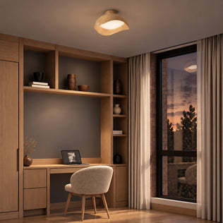 An Adara 15 in. (38 cm) Modern LED Flush Mount Ceiling Light 5 CCT, featuring a curved, wood-toned design, installed in a home office.