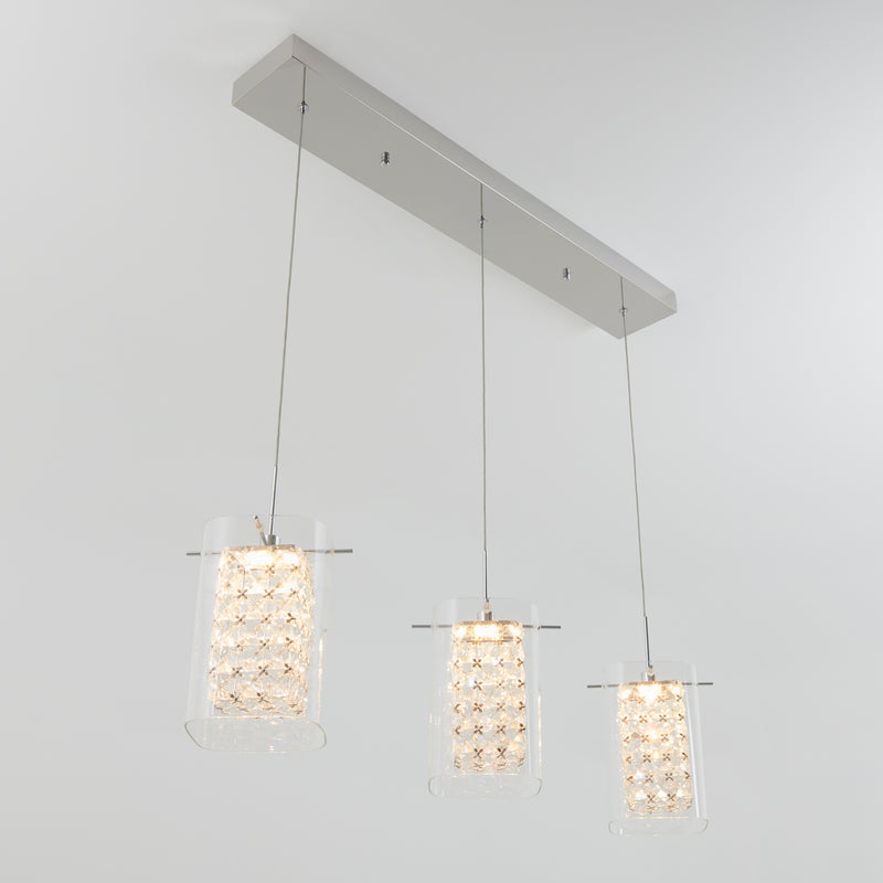 The Artika Crystal Cube 3-light LED pendant features three hanging lights with textured geometric glass shades, each suspended from a rectangular metallic ceiling mount.
