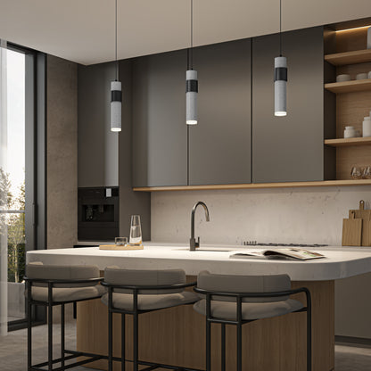 Modern kitchen with gray cabinets, a marble island with three cushioned bar stools, Artika Barden 1-light LED pendant above, open shelves with decor, and a built-in coffee machine by a large window.