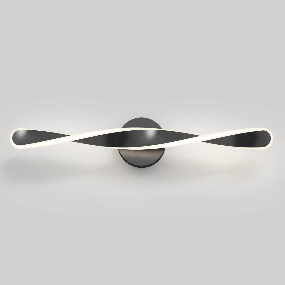 A modern wall light fixture with a twisted, ribbon-like design in black and white, mounted on a circular base against a plain gray background.