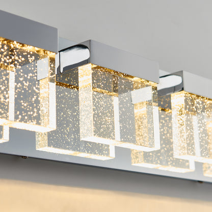 Close-up of the Artika Bubble Cube 4-light LED bathroom vanity light, featuring rectangular bubble glass shades and chrome accents illuminated by warm LED lighting.