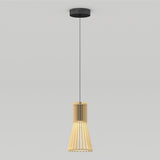 A modern pendant light with a cylindrical wooden slat shade, suspended from the ceiling by a thin black cord and a round black ceiling mount, against a plain white background.
