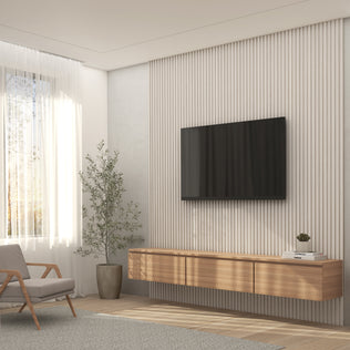 A modern living room featuring the Artika Panolok 30.67 ft wall panel kit (pack of 8), a large wall-mounted TV, wooden floating console, gray armchair, potted plant, and sheer curtains letting in natural light.