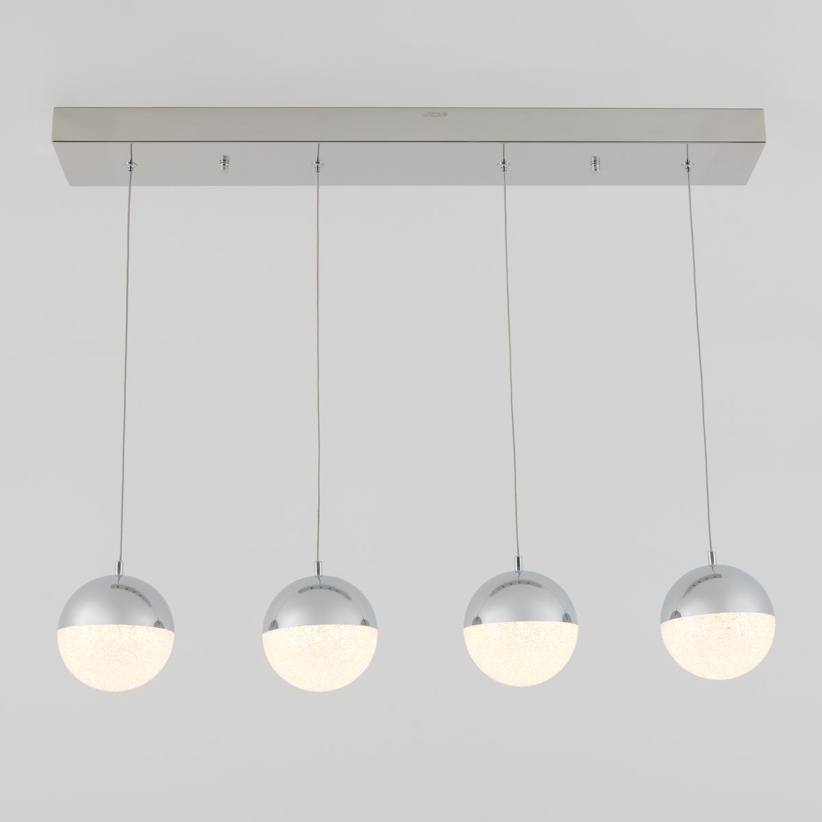 The Artika Sparkle 4-light LED pendant features four spherical lights with chrome tops and frosted bottoms, suspended in a row from a rectangular ceiling mount against a plain white background.